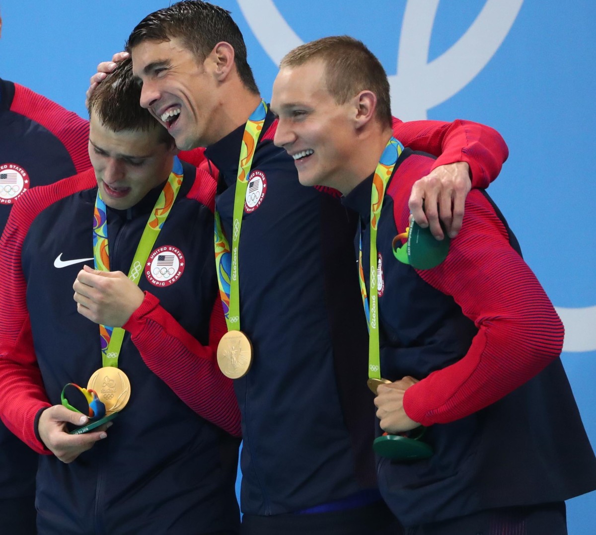Ryan Held (far left) shows his emotion with teammates Michael Phelps and Nathan Adrian