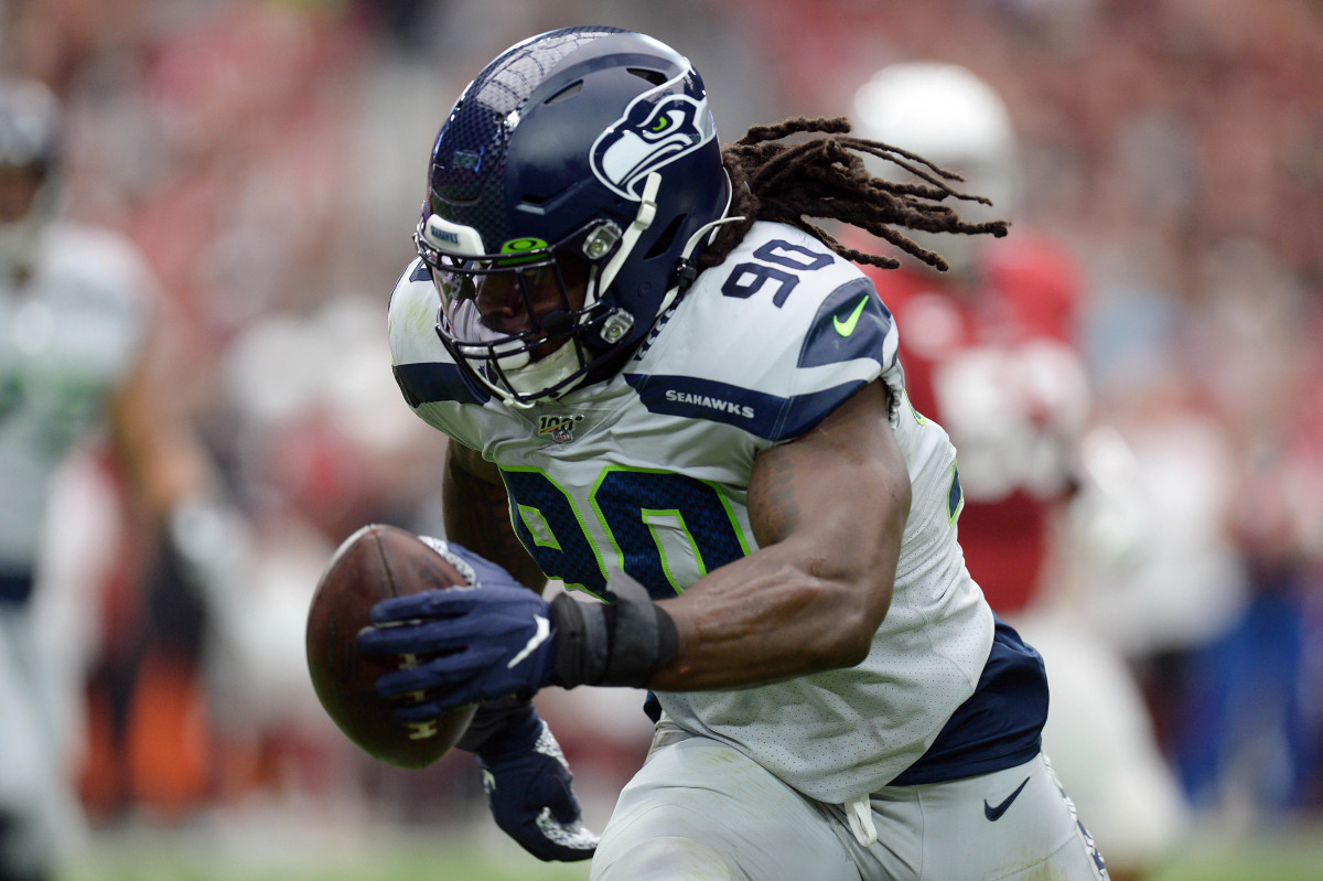 Seattle Seahawks outside linebacker Jadeveon Clowney (90) returns an interception for a touchdown against the Arizona Cardinals during the first half at State Farm Stadium.
