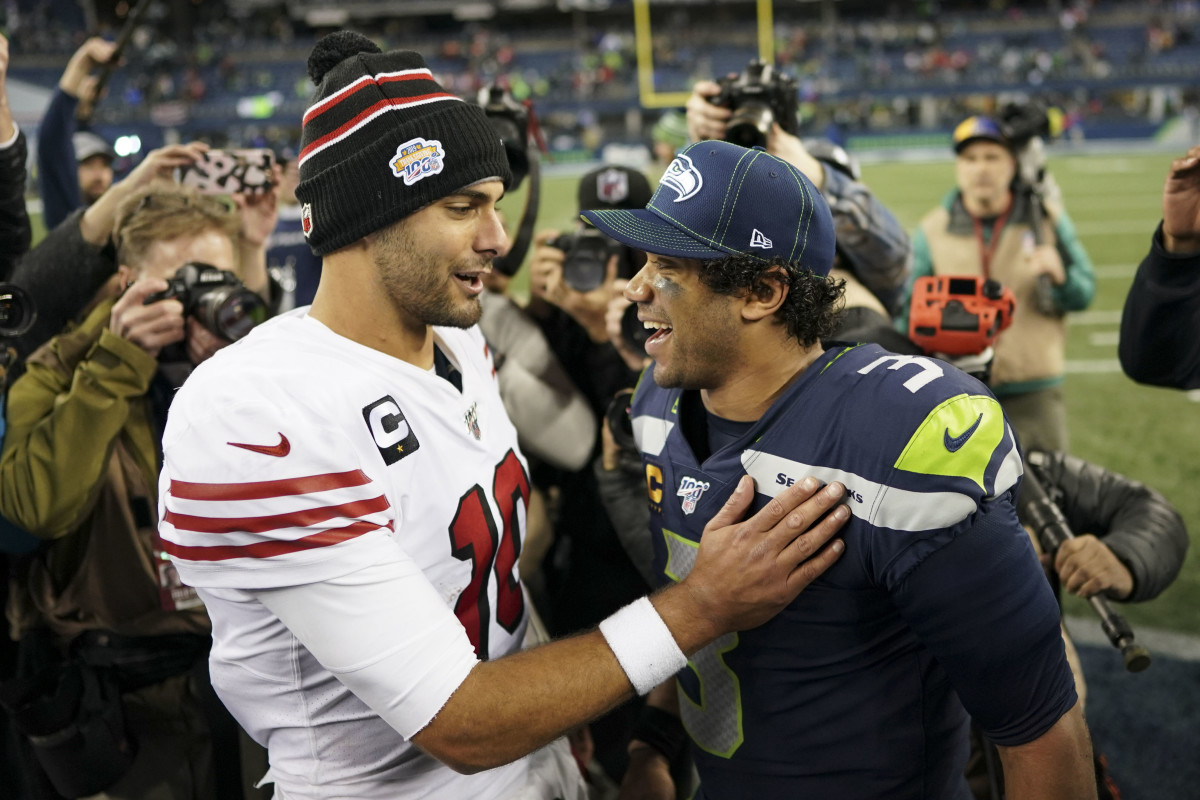 San Francisco 49ers quarterback Jimmy Garoppolo (10, left) talks to Seattle Seahawks quarterback Russell Wilson (3, right) after the game at CenturyLink Field.