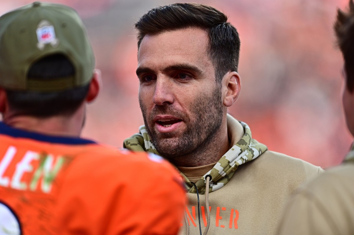 Denver Broncos quarterback Joe Flacco (5) talks to quarterback Brandon Allen (2) in the second quarter against the Cleveland Browns at Empower Field at Mile High.