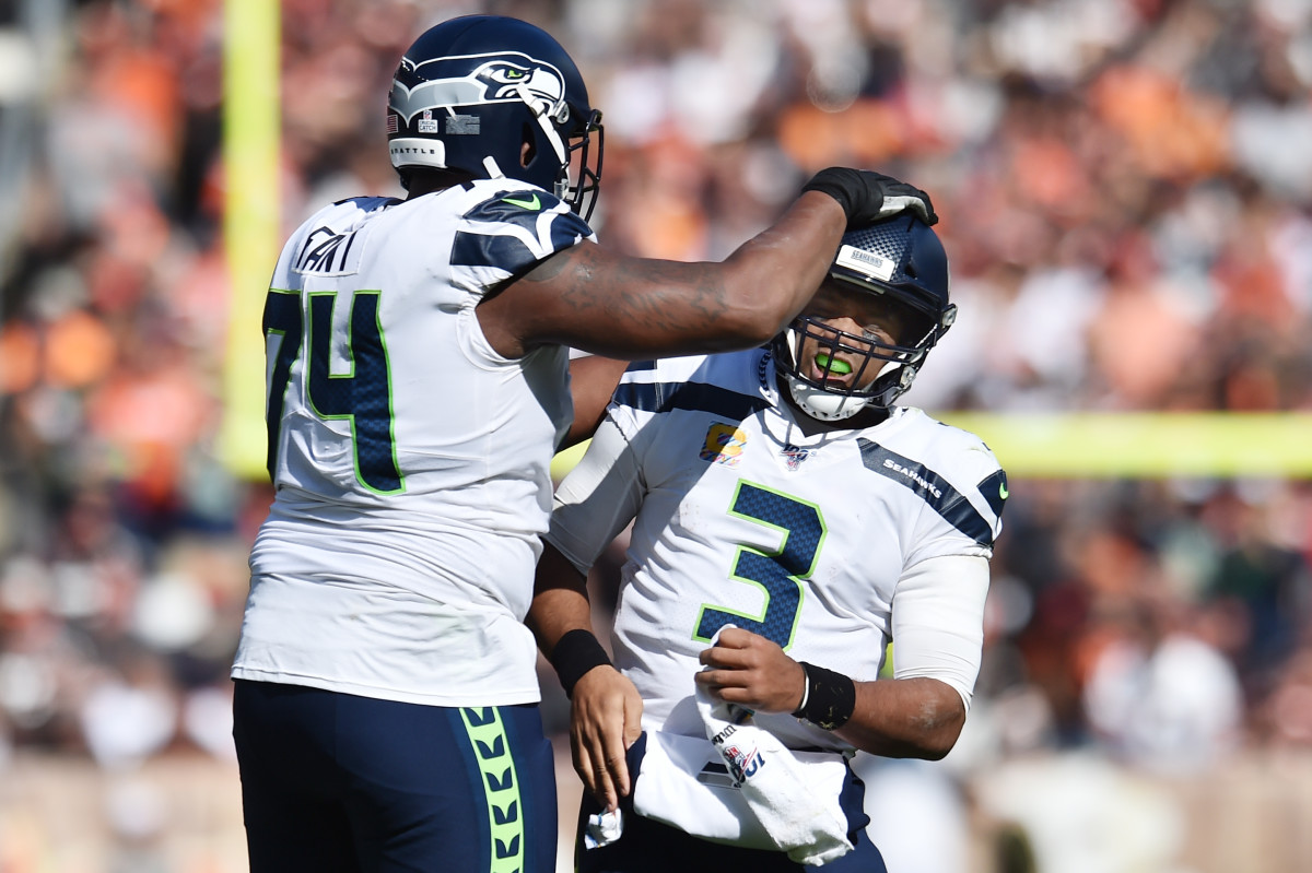 Seattle Seahawks offensive tackle George Fant (74) and quarterback Russell Wilson (3) celebrates after a touchdown during the first half at FirstEnergy Stadium.