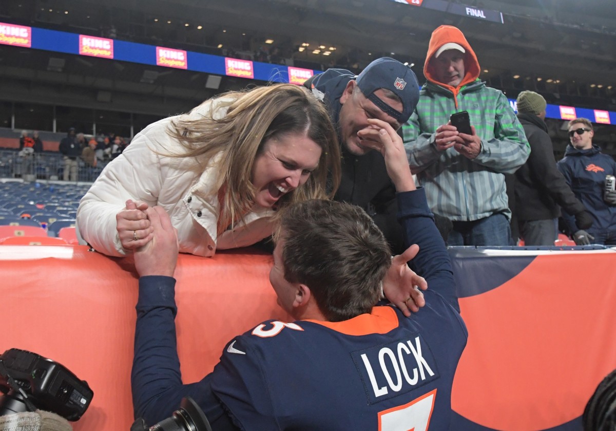 Denver Broncos quarterback Drew Lock (3) celebrates with his mother Laura Lock and father Andy Lock after the game against the Los Angeles Chargers Empower Field at Mile High.The Broncos defeated the Chargers 23-20.