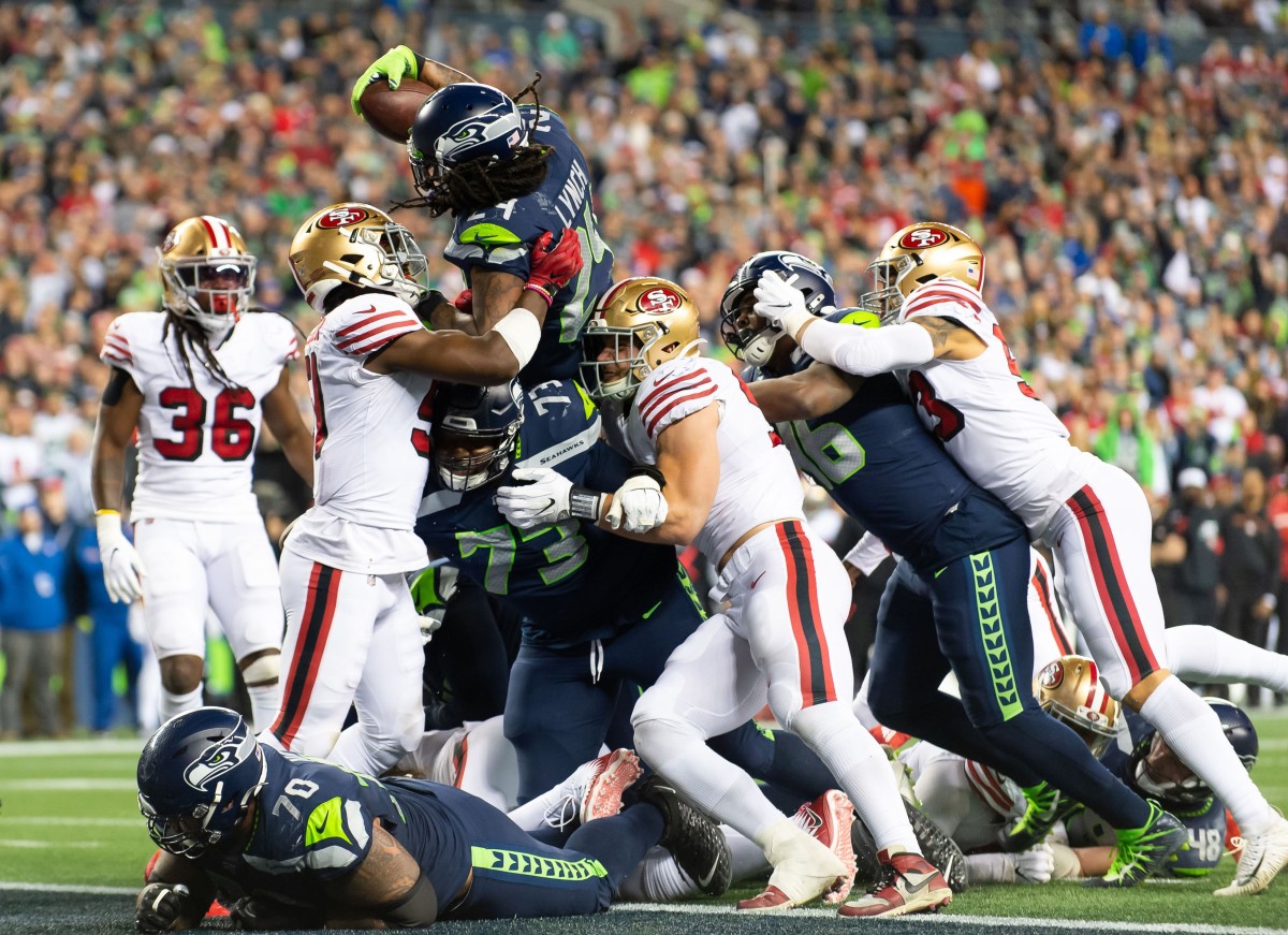 Seattle Seahawks running back Marshawn Lynch (24) scores a touchdown against the San Francisco 49ers during the second half at CenturyLink Field.