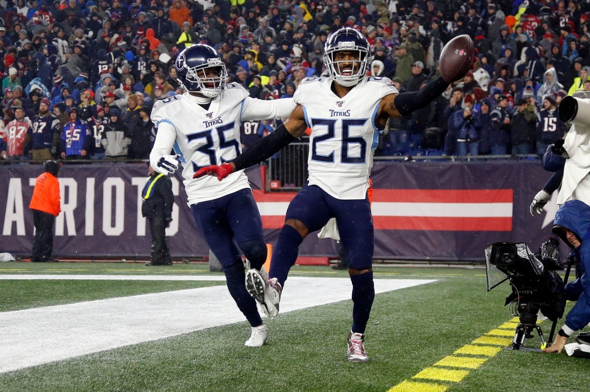 Tennessee Titans cornerback Logan Ryan (26) celebrates with defensive back Tramaine Brock (35) after scoring a touchdown on an interception against the New England Patriots during the second half at Gillette Stadium.