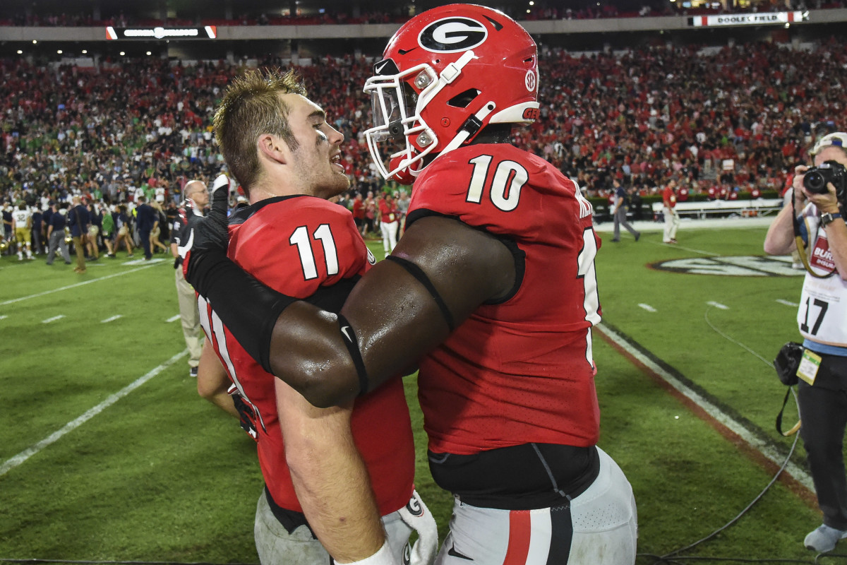 Malik Herring and Jake Fromm celebrate the Notre Dame victory. 