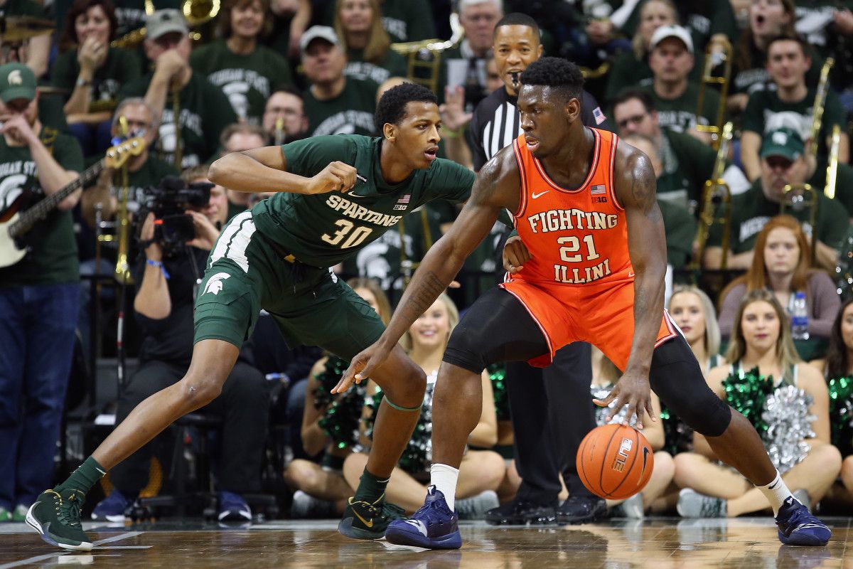Illinois Fighting Illini center Kofi Cockburn (21) is defended by Michigan State Spartans forward Marcus Bingham Jr. (30) during the second half of a game at the Breslin Center.