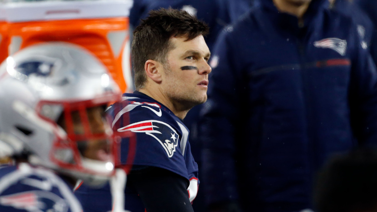 Tom Brady looks on the field during the Patriots' playoff loss to the Tennessee Titans