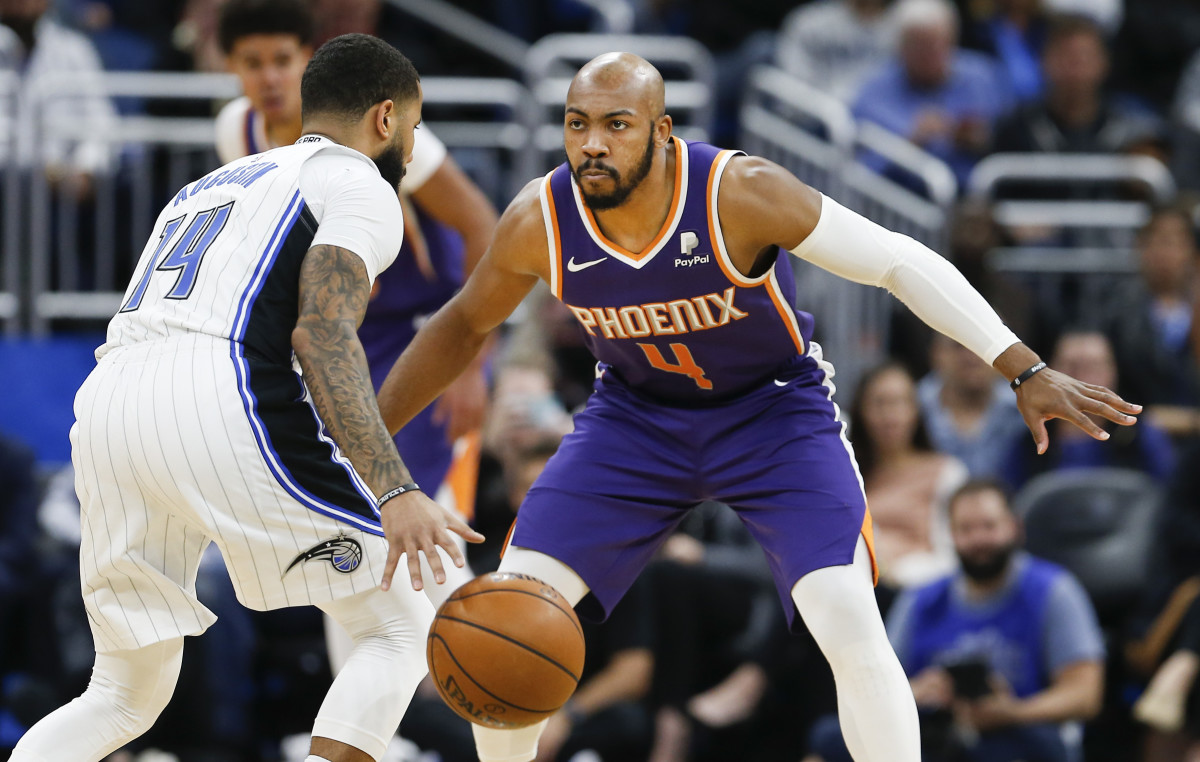 Phoenix Suns guard Jevon Carter (4) guards Orlando Magic guard D.J. Augustin (14) during the second half at Amway Center.
