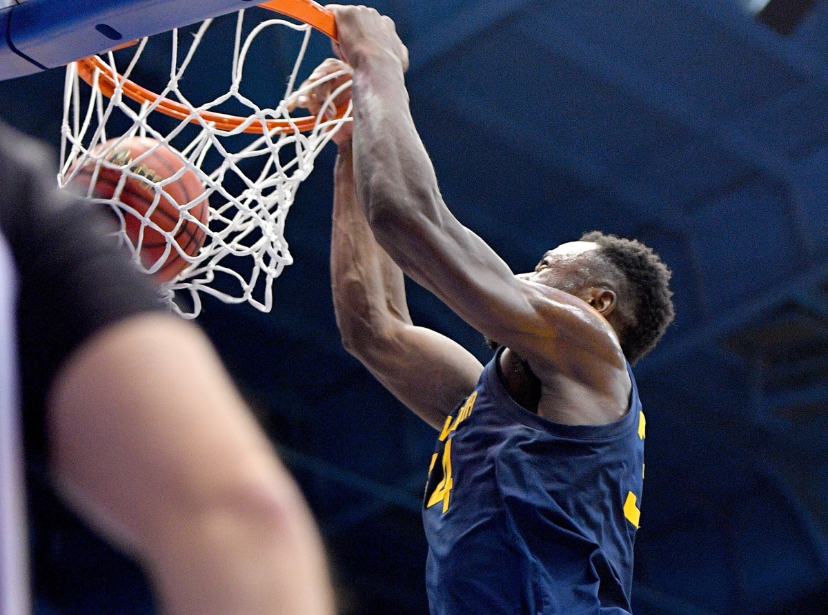 West Virginia Mountaineers forward Oscar Tshiebwe (34) dunks the ball during the first half against the Kansas Jayhawks at Allen Fieldhouse.