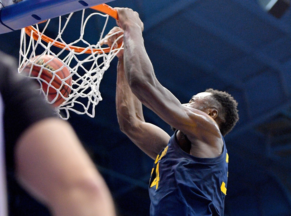 West Virginia Mountaineers forward Oscar Tshiebwe (34) dunks the ball during the first half against the Kansas Jayhawks at Allen Fieldhouse.