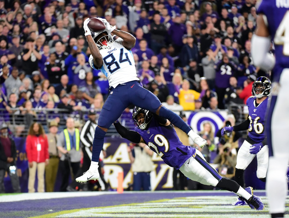 Tennessee Titans wide receiver Corey Davis (84) catches a touchdown pass over Baltimore Ravens safety Earl Thomas III (29) in the third quarter in a AFC Divisional Round playoff football game at M&T Bank Stadium.