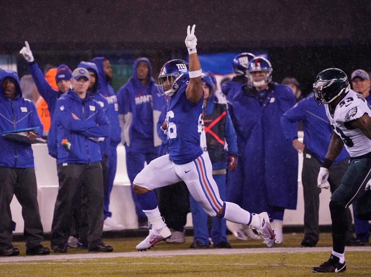 Dec 29, 2019; East Rutherford, New Jersey, USA; New York Giants running back Saquon Barkley (26) scores a touchdown against the Philadelphia Eagles in the second half at MetLife Stadium.