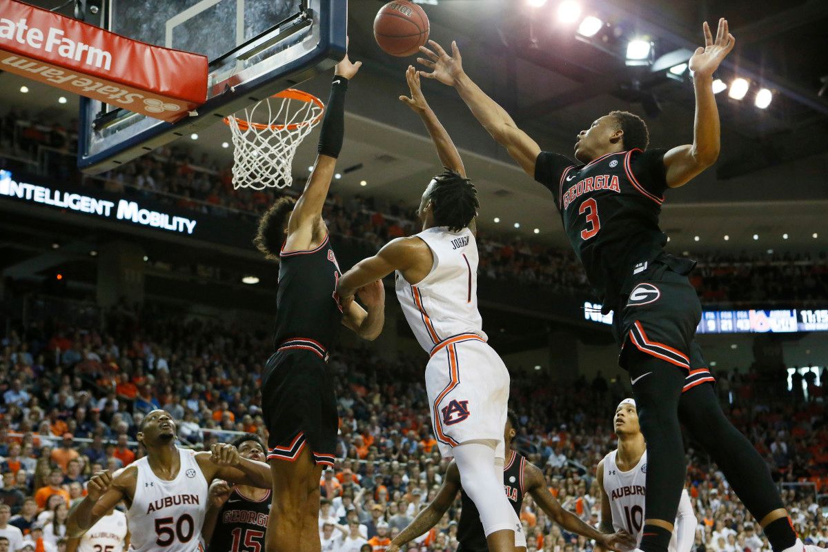 Freshmen, Christian Brown and Toumani Camara contest a shot.