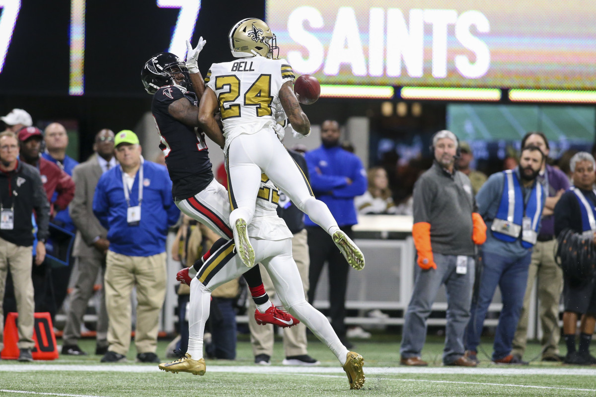 Nov 28, 2019; Atlanta, GA, USA; Atlanta Falcons wide receiver Calvin Ridley (18) is interfered with by New Orleans Saints cornerback Marshon Lattimore (23) and strong safety Vonn Bell (24) in the first half at Mercedes-Benz Stadium. Mandatory Credit: Brett Davis-USA TODAY Sports