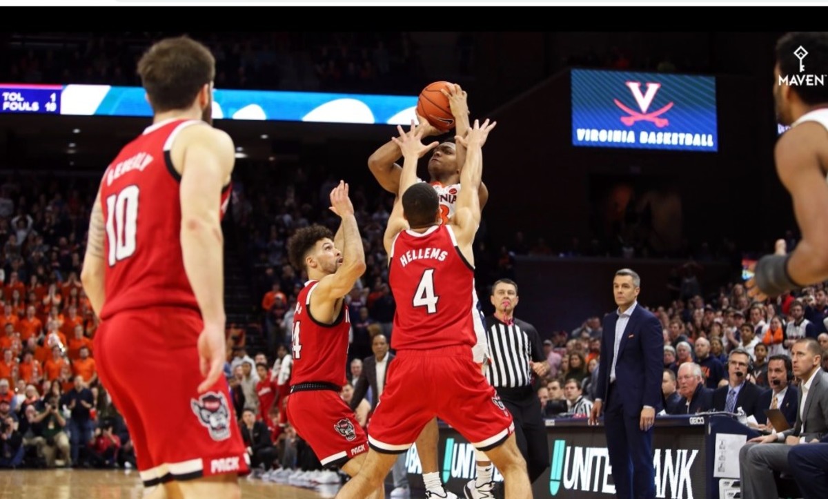 NC States Jericole Hellems and Devon Daniels defend Virginia's Casey Morsell on the game's final shot