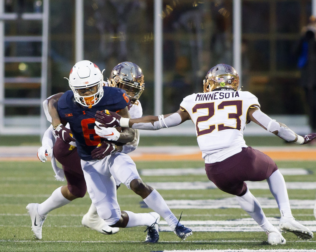 Illinois Fighting Illini wide receiver Dominic Stampley (6) is tackled by Minnesota Golden Gophers defensive back Chris Williamson (6) during the fourth quarter at Memorial Stadium.