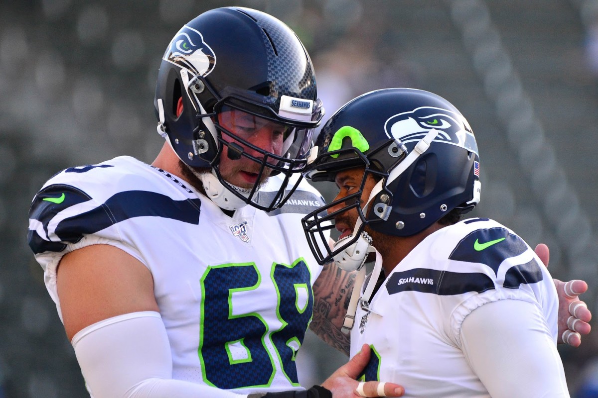 Seattle Seahawks center Justin Britt (68) and quarterback Russell Wilson (3) talk before the game against the Los Angeles Chargers at Dignity Health Sports Park.