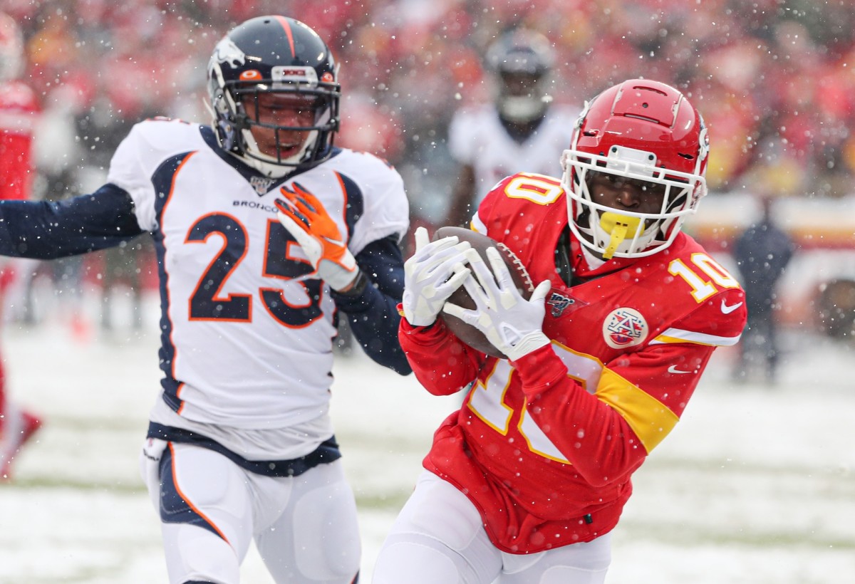 Kansas City Chiefs wide receiver Tyreek Hill (10) catches a pass for a touchdown against Denver Broncos cornerback Chris Harris (25) during the first half at Arrowhead Stadium.