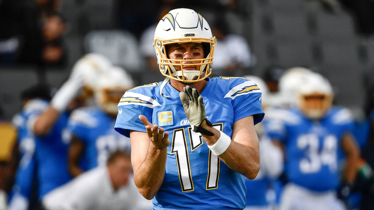 Philip Rivers claps while with the Chargers.