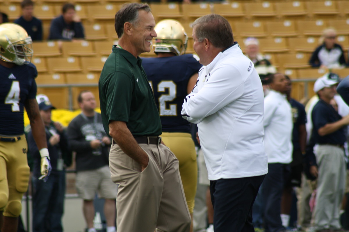 Brian Kelly Notre Dame head coach and Mark Dantonio visit prior to the 2013 game in South Bend.  Photo courtesy of Mark Boomgaard.