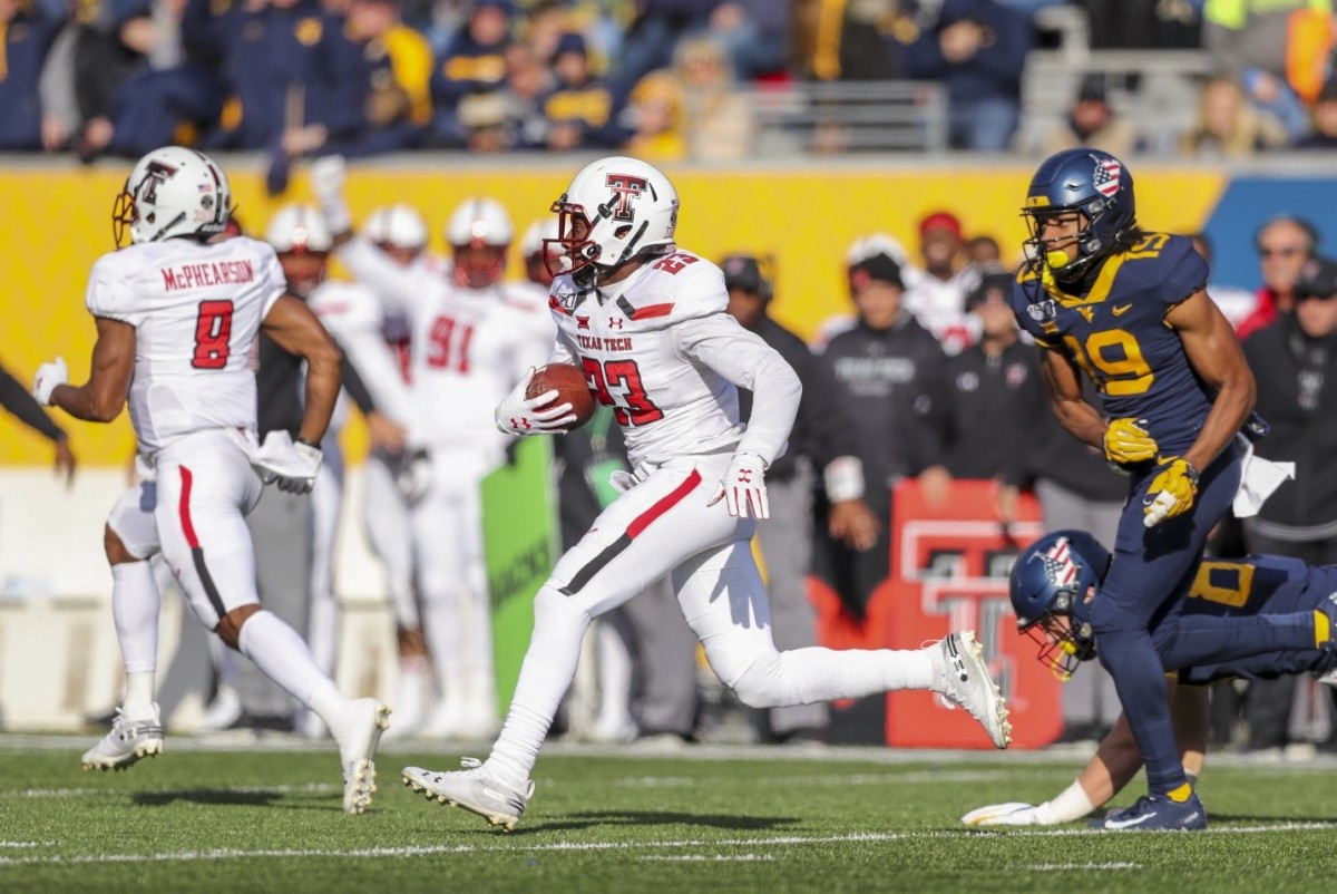 Nov 9, 2019; Morgantown, WV, USA; Texas Tech Red Raiders defensive back Damarcus Fields (23) returns an interception against the West Virginia Mountaineers during the third quarter at Mountaineer Field at Milan Puskar Stadium. Mandatory Credit: Ben Queen-USA TODAY Sports