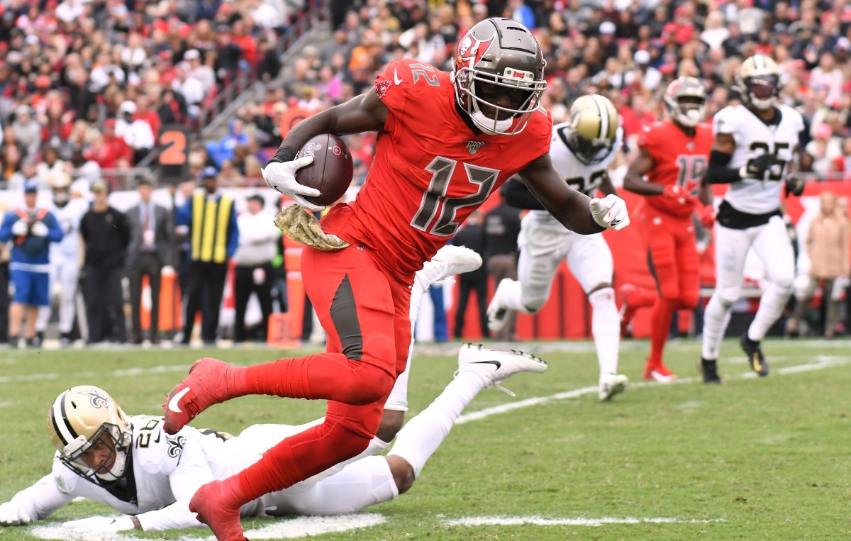 Nov 17, 2019; Tampa, FL, USA; Tampa Bay Buccaneers wide receiver Chris Godwin (12) scores a touchdown against the New Orleans Saints in the second half at Raymond James Stadium. Mandatory Credit: Jonathan Dyer-USA TODAY Sports