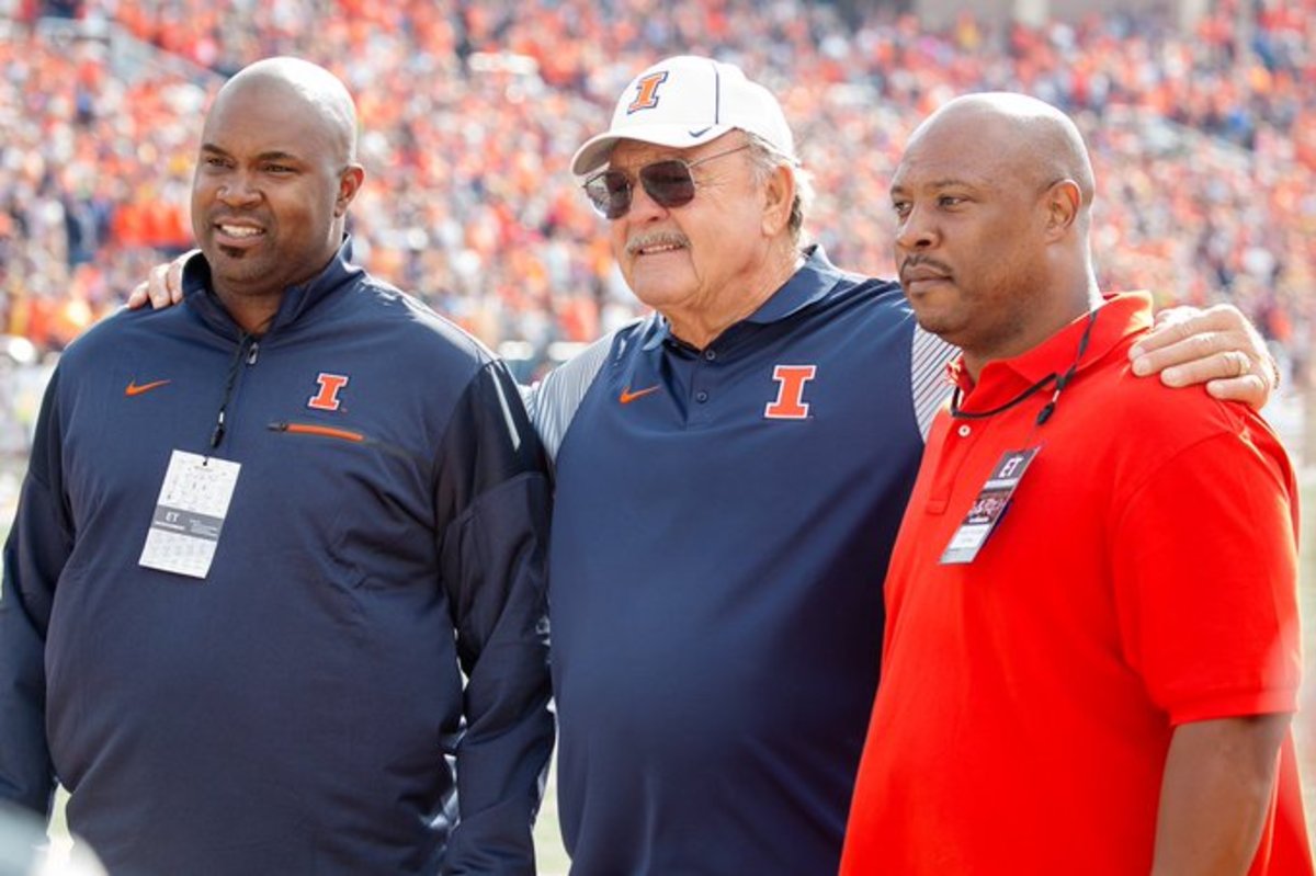 Dick Butkus (middle) poses for a photo with Kevin Hardy (left) and Dana Howard (right) during the 2016 Illinois Homecoming game in Champaign, Ill. 