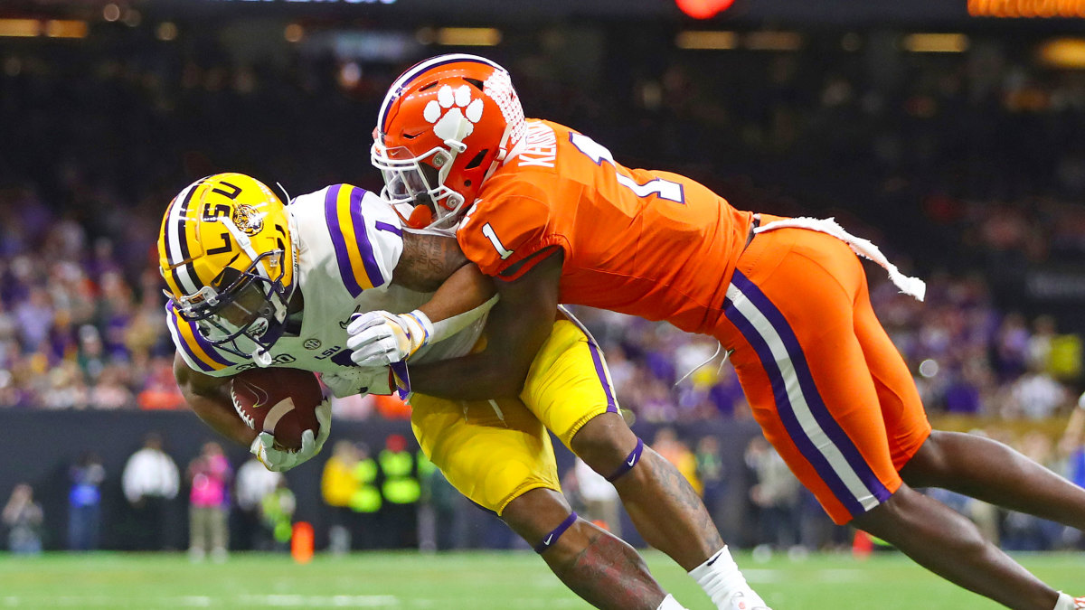 LSU's JaMarr Chase is tackled by a Clemson football player