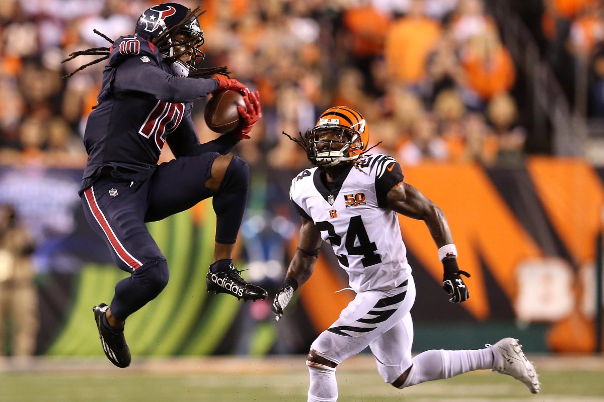 Houston Texans wide receiver DeAndre Hopkins (10) leaps to make a catch as Cincinnati Bengals cornerback Adam Jones (24) defends during a 2017 game.