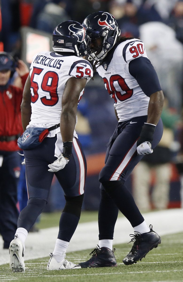 Texans outside linebacker Whitney Mercilus (59) celebrates with defensive end Jadeveon Clowney (90) against the Patriots during a playoff game in the 2016 season.