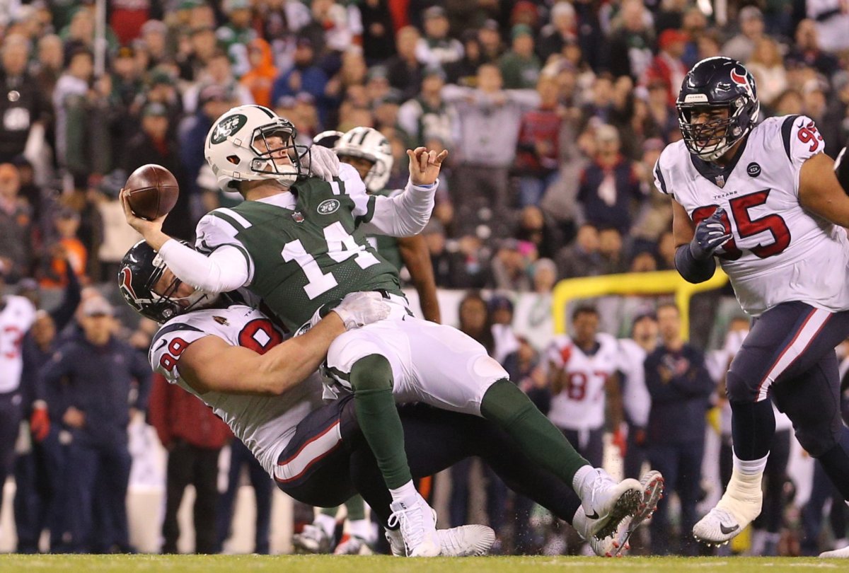 Jets quarterback Sam Darnold (14) is sacked by Texans defensive end J.J. Watt (99) during a 2018 matchup.