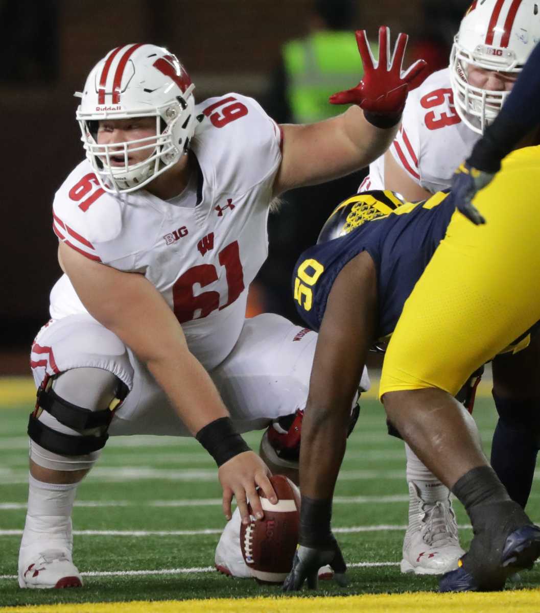 Wisconsin offensive lineman Tyler Biadasz (61) makes an adjustment at the line during the third quarter of their game Saturday, October 13, 2018 at Michigan Stadium in Ann Arbor, Mich. In 2020, Wisconsin will have to replace Biadasz at center.