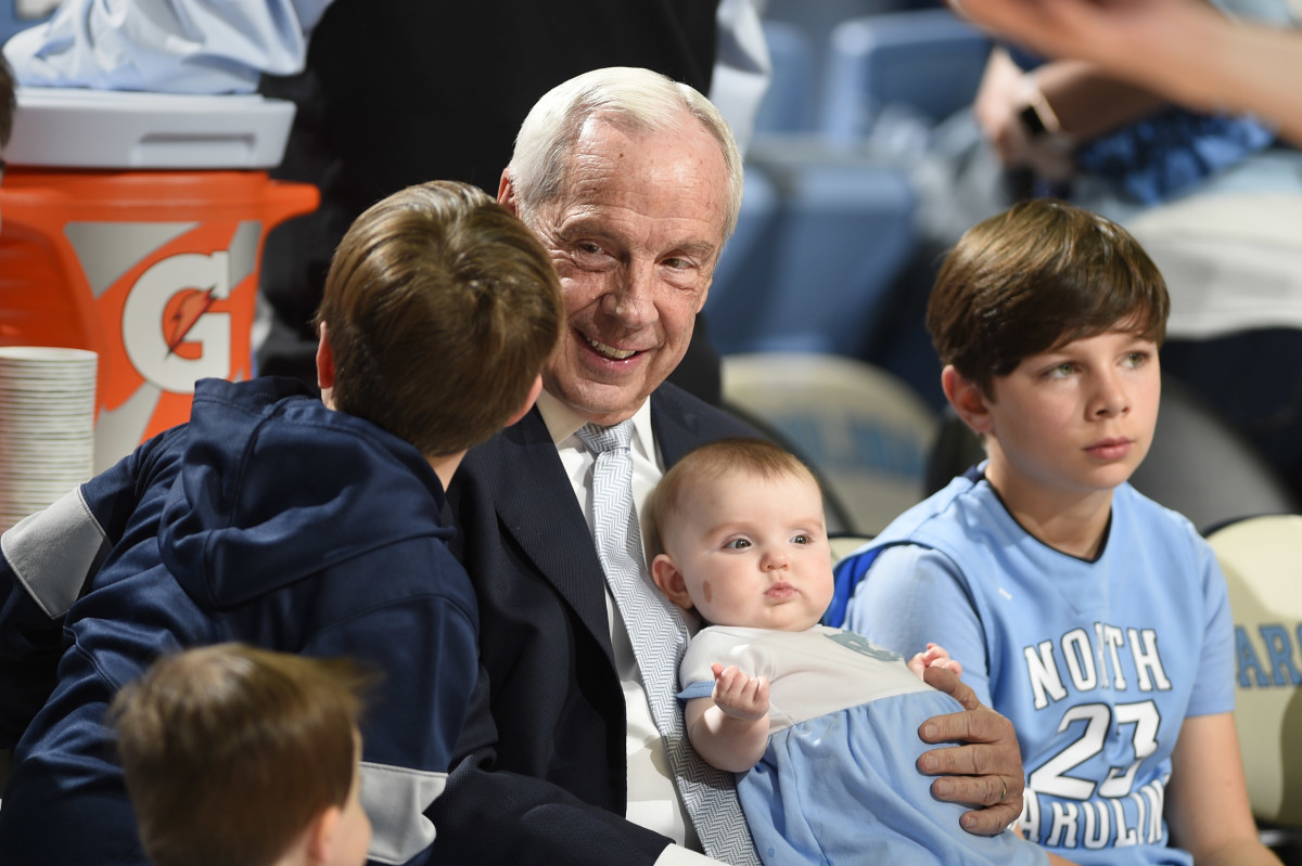 North Carolina Tar Heels head coach Roy Williams holds his granddaughter Kenzie Newlin before a game at Dean E. Smith Center.