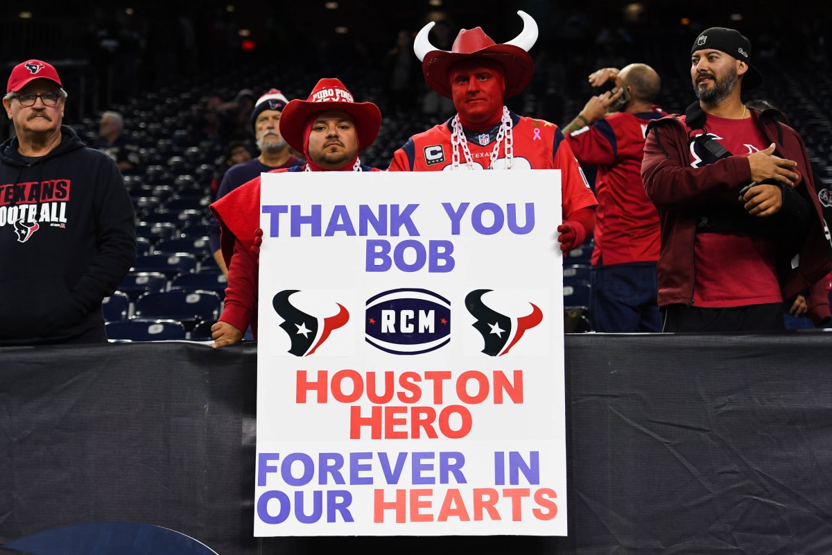 Texans fans hold a sign in honor of the late owner Robert McNair (also known as Bob McNair) before a 2018 game against the Titans at NRG Stadium.
