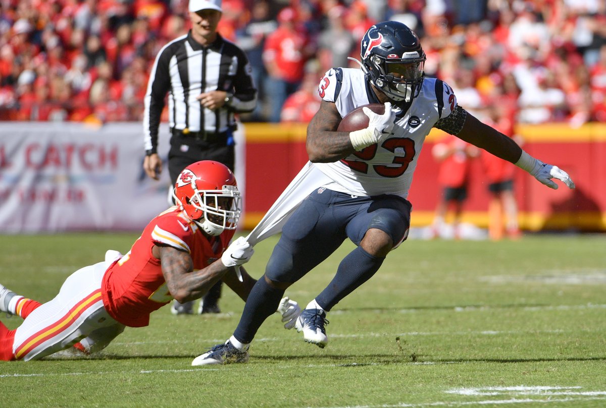 Texans running back Carlos Hyde (23) runs the ball as Chiefs defensive back Bashaud Breeland (21) attempts the tackle during a 2019 game at Arrowhead Stadium.