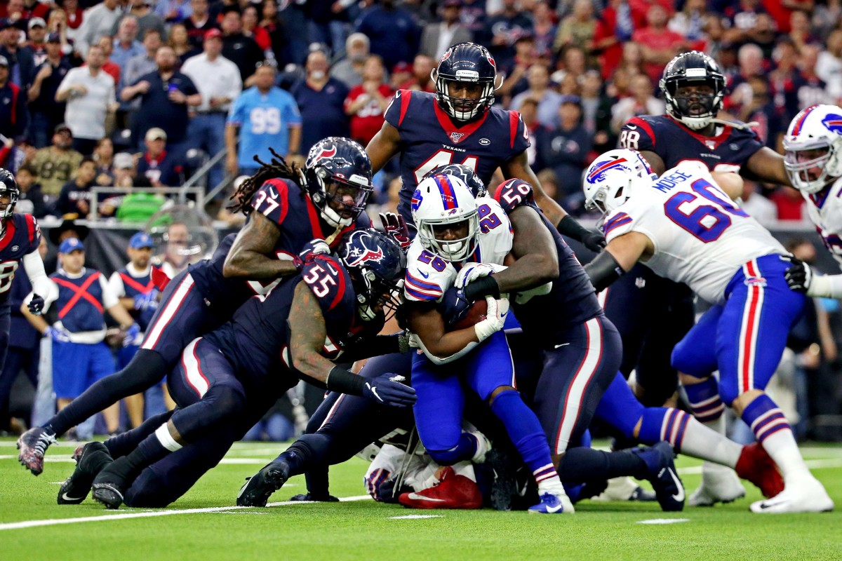 Texans outside linebacker Whitney Mercilus (59) tackles Bills running back Devin Singletary (26) during the AFC Wild Card Playoff game on Jan. 4, 2020.
