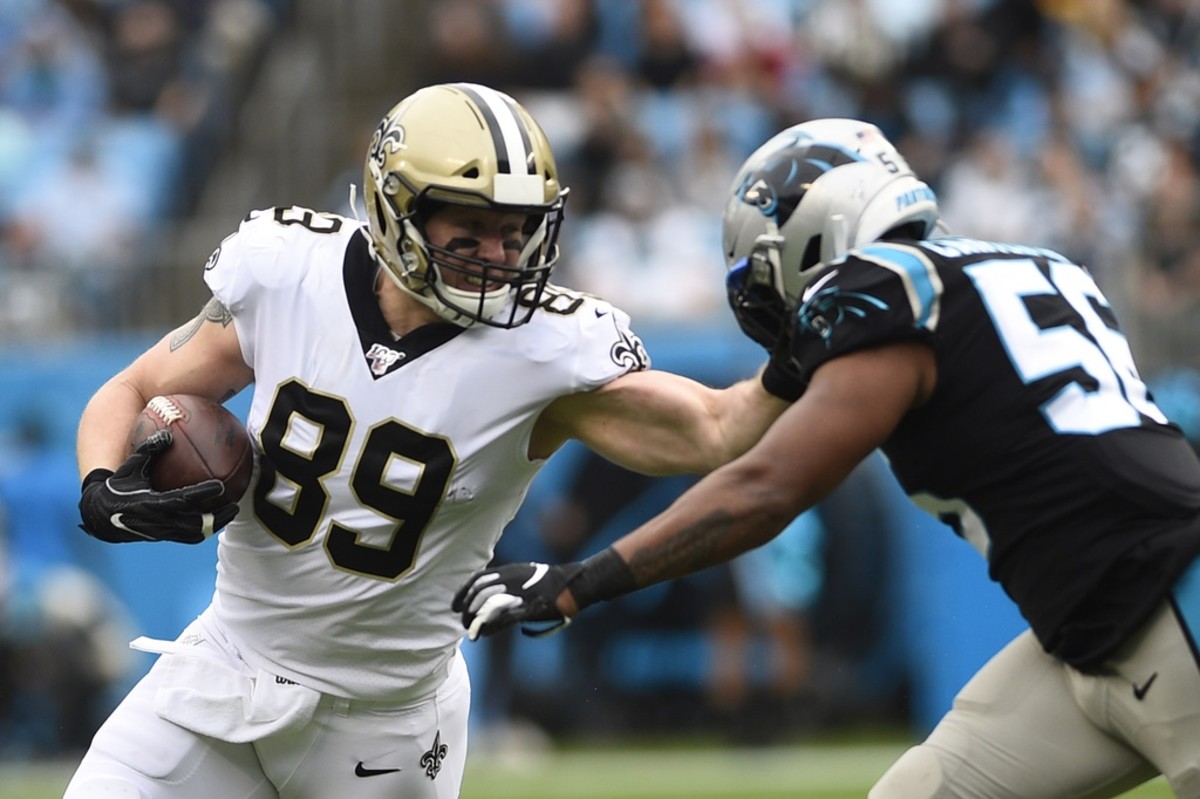 Dec 29, 2019; Charlotte, North Carolina, USA; New Orleans Saints tight end Josh Hill (89) with the ball as Carolina Panthers linebacker Jermaine Carter (56) defends in the first quarter at Bank of America Stadium. Mandatory Credit: Bob Donnan-USA TODAY