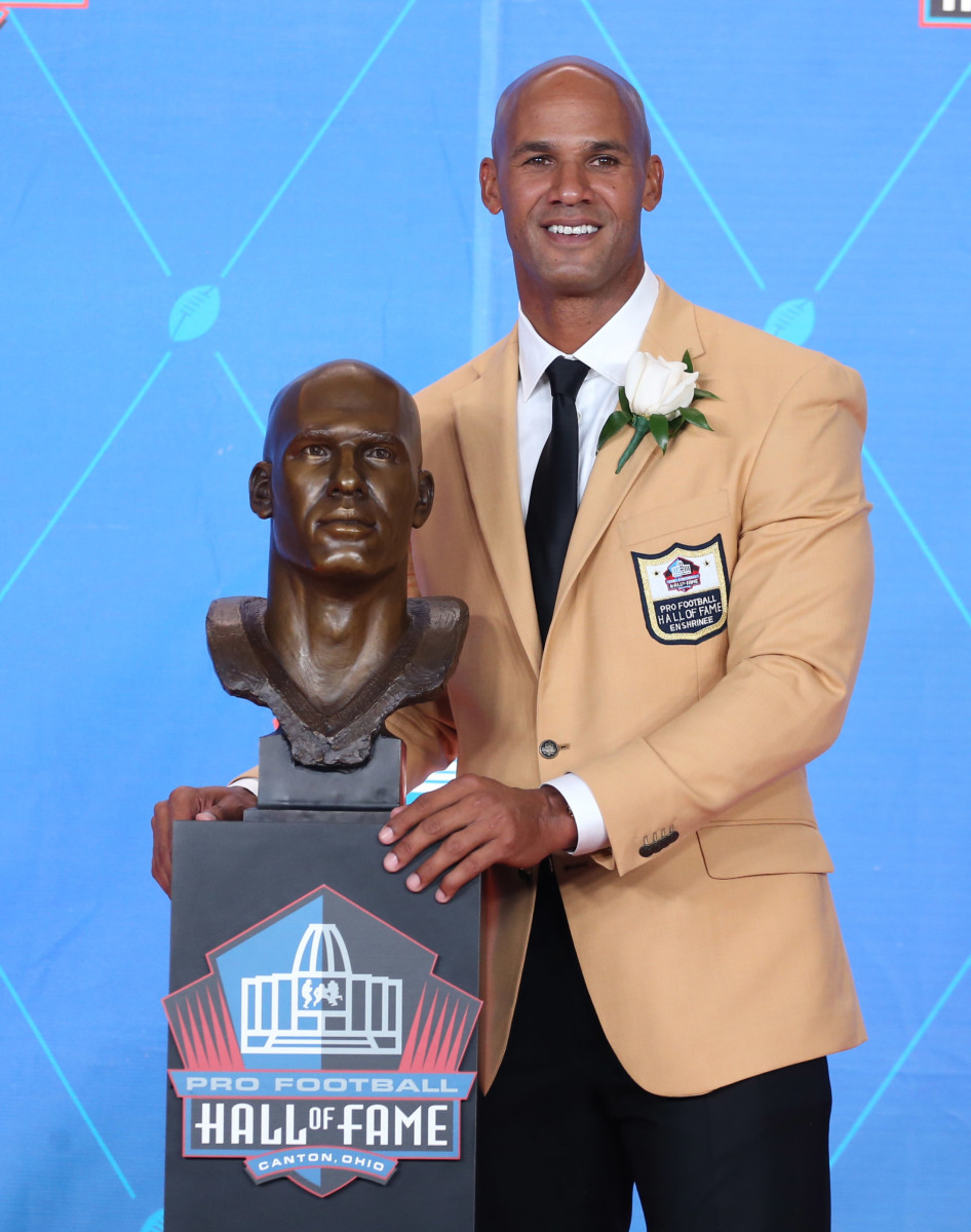 Miami Dolphins former linebacker Jason Taylor poses with his bust during the Professional Football HOF enshrinement ceremonies at the Tom Benson Hall of Fame Stadium.