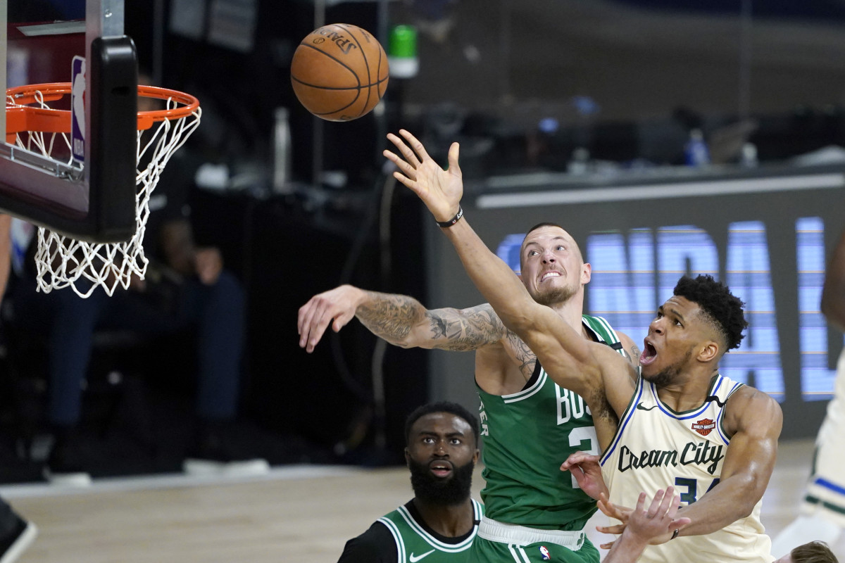 Milwaukee Bucks' Giannis Antetokounmpo, right, heads to the basket as Boston Celtics' Daniel Theis defends during the second half of an NBA basketball game Friday, July 31, 2020,