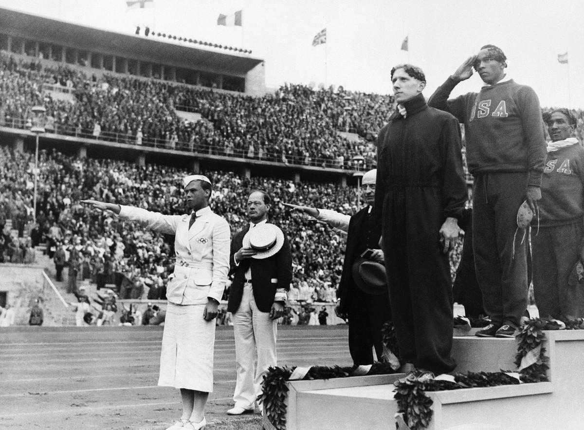 Owens (top) took gold in the 100-meter final in Berlin, in 1936, overshadowing for a moment what amounted to a Nazi rally.