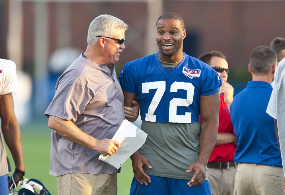 Offensive coordinator Kevin Gilbride with New York Giants defensive end Osi Umenyiora (72) New York Giants Camp.