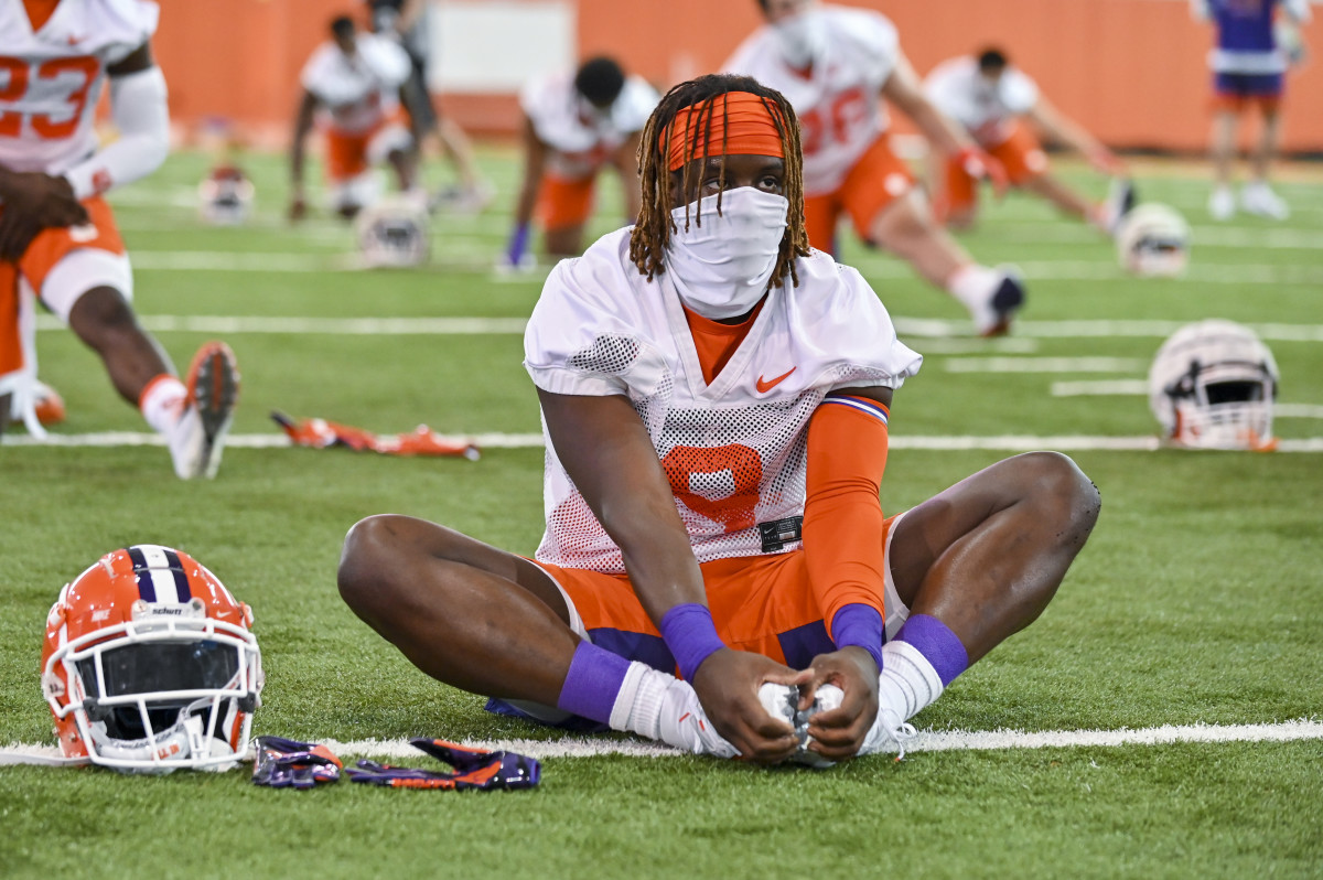 Clemson players warm-up Thursday wearing masks to protect themselves from Covid-19. Some Pac-12 and Big 10 players have said they will boycott the season if their respective conferences don't have a better plan to keep players safe this season. 