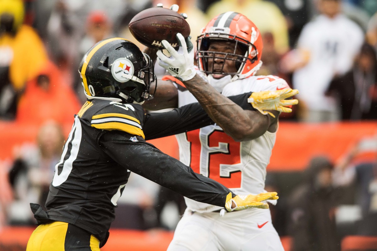 Browns wide receiver Josh Gordon (12) catches a touchdown as Steelers cornerback Cameron Sutton (20) defends in a 2018 game. Gordon is Cleveland's single-game and single-season record holder for receiving yardage.