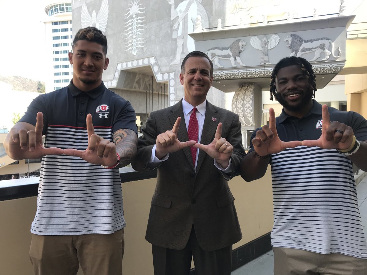 Utah athletic director Mark Harlan, middle, at the 2019 Pac-12 media days with current Dallas Cowboy Bradlee Anae, left, and current Buffalo Bill Zack Moss, right.