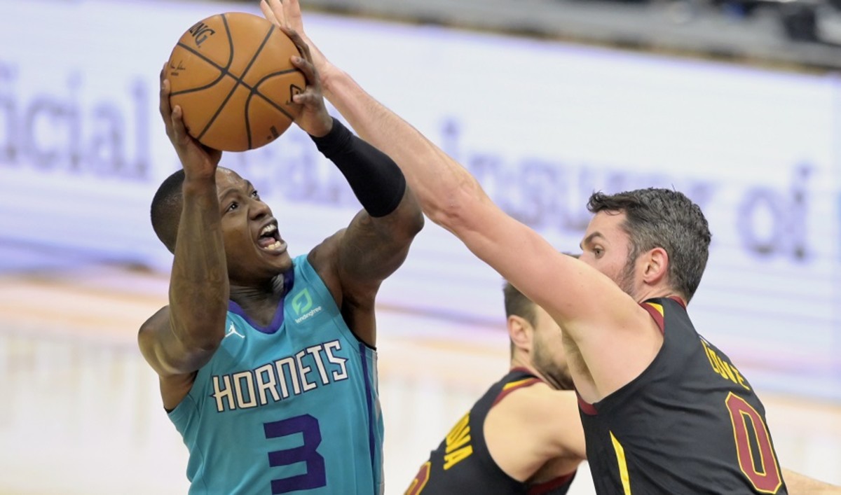 Charlotte Hornets guard Terry Rozier shoots against Cleveland Cavaliers forward Kevin Love during a game at Rocket Mortgage FieldHouse in December.
