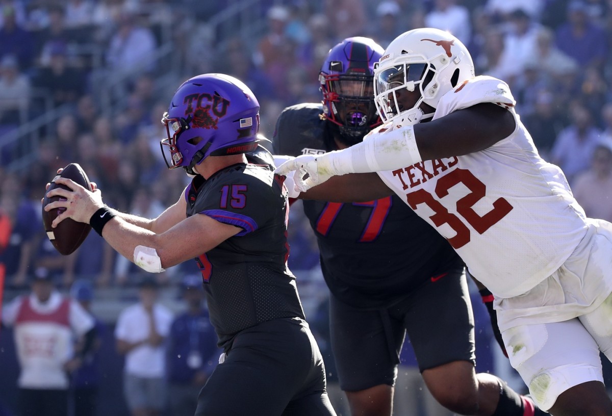 Oct 26, 2019; Fort Worth, TX, USA; Texas Longhorns defensive lineman Malcolm Roach (32) chases TCU Horned Frogs quarterback Max Duggan (15) during the second quarter at Amon G. Carter Stadium. Mandatory Credit: Kevin Jairaj-USA TODAY Sports