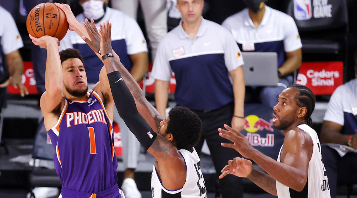 Aug 4, 2020; Lake Buena Vista, USA; Devin Booker #1 of the Phoenix Suns shoots the game winning basket over Paul George #13 of the LA Clippers at The Arena at ESPN Wide World Of Sports Complex on August 04, 2020 in Lake Buena Vista, Florida.