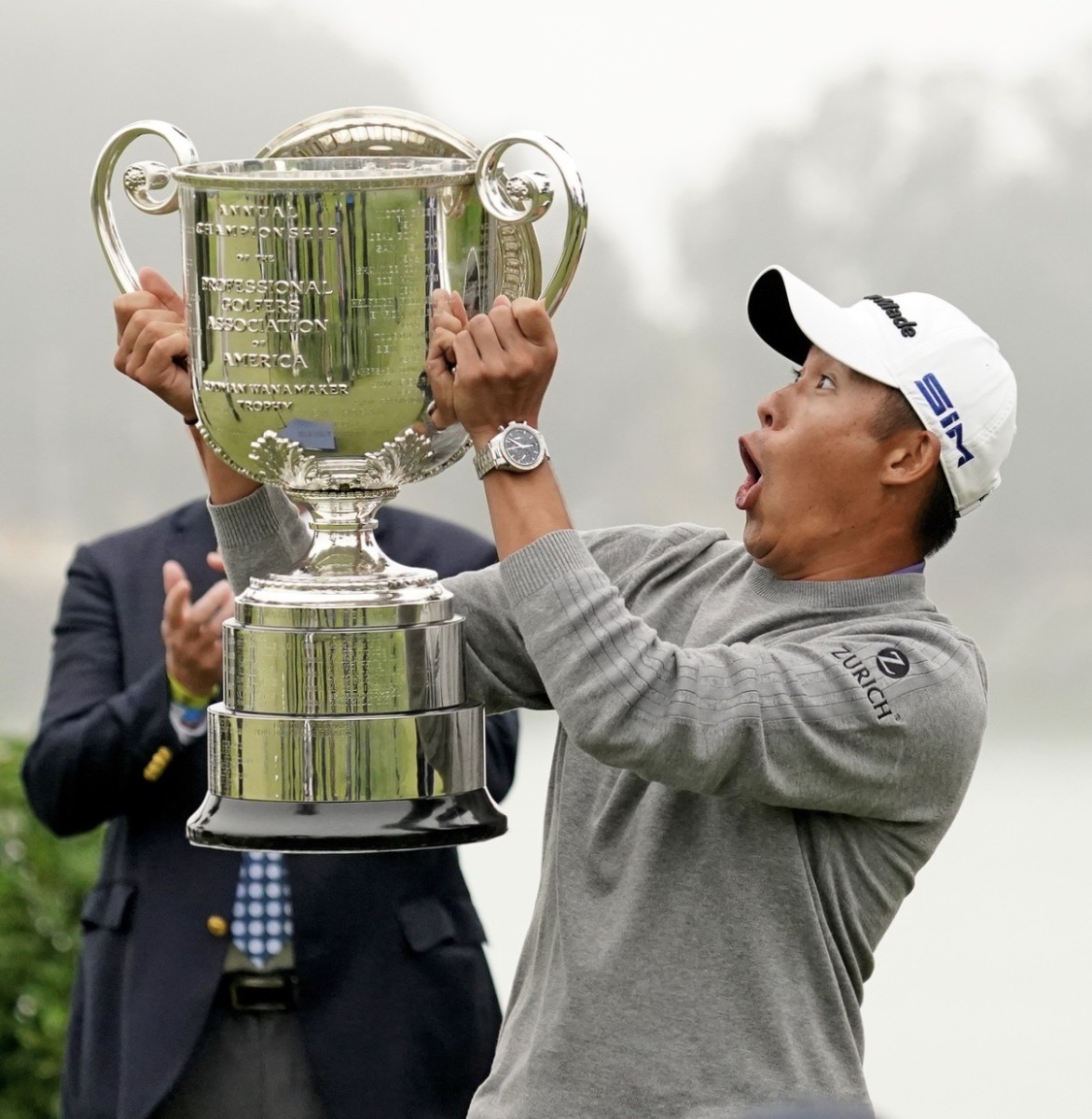 Collin Morikawa reacts with shock when the top of the Wanamaker Trophy falls off during his victory ceremony.