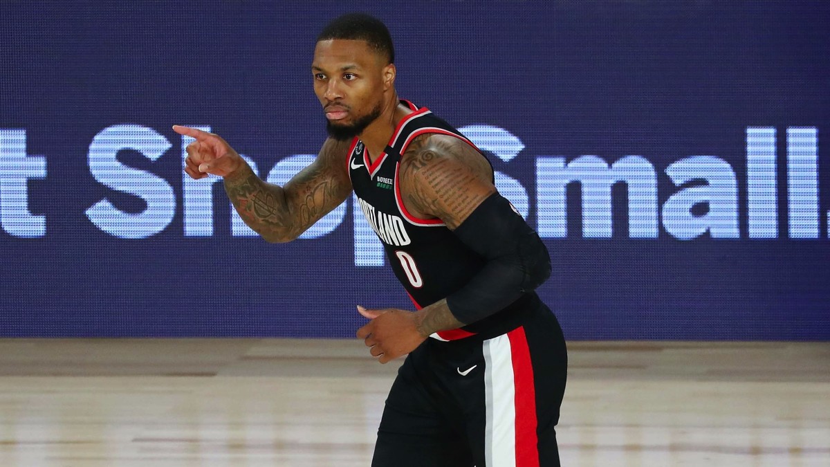 Portland Trail Blazers guard Damian Lillard (0) reacts after making a three point basket against the Dallas Mavericks during the second half of a NBA game at The Field House.