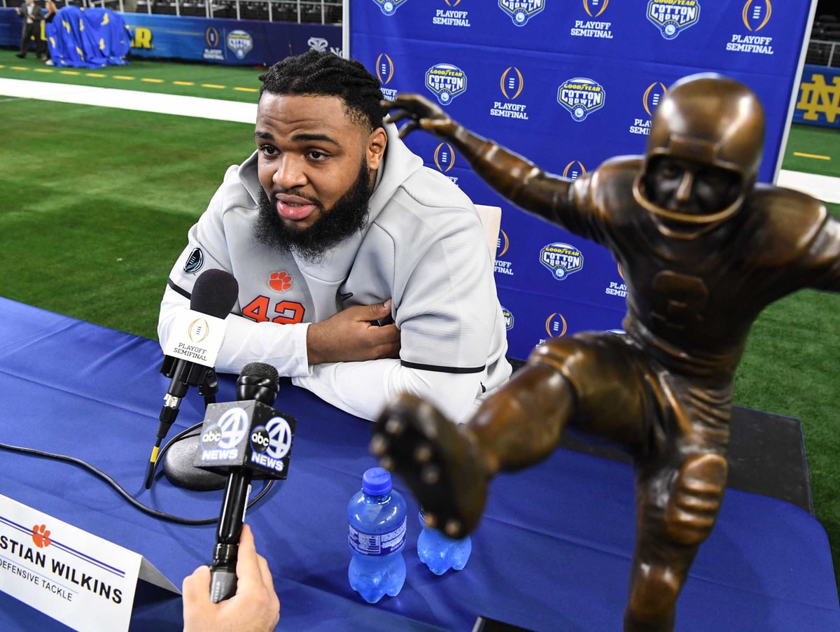 Clemson defensive lineman Christian Wilkins talks near his William V. Campbell Trophy during Media Day for Clemson and Notre Dame at the AT&T Stadium in Dallas. (© Ken Ruinard / staff)